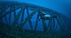 Diver Kim on his Rebreather at 35m inspecting one of the ... by Mick Tait 